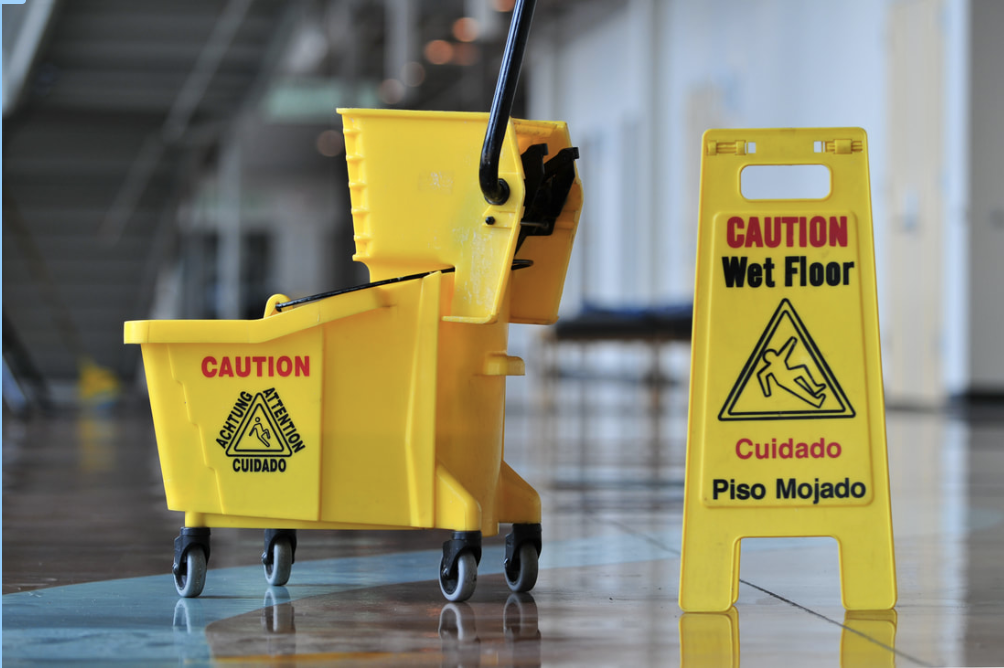 Picture of mop bucket and wet floor sign